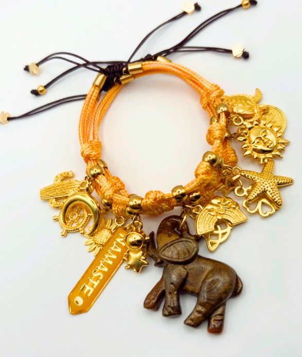 Pulsera de dijes naranja con elefante y detalles dorados: joya bohemia ajustable.