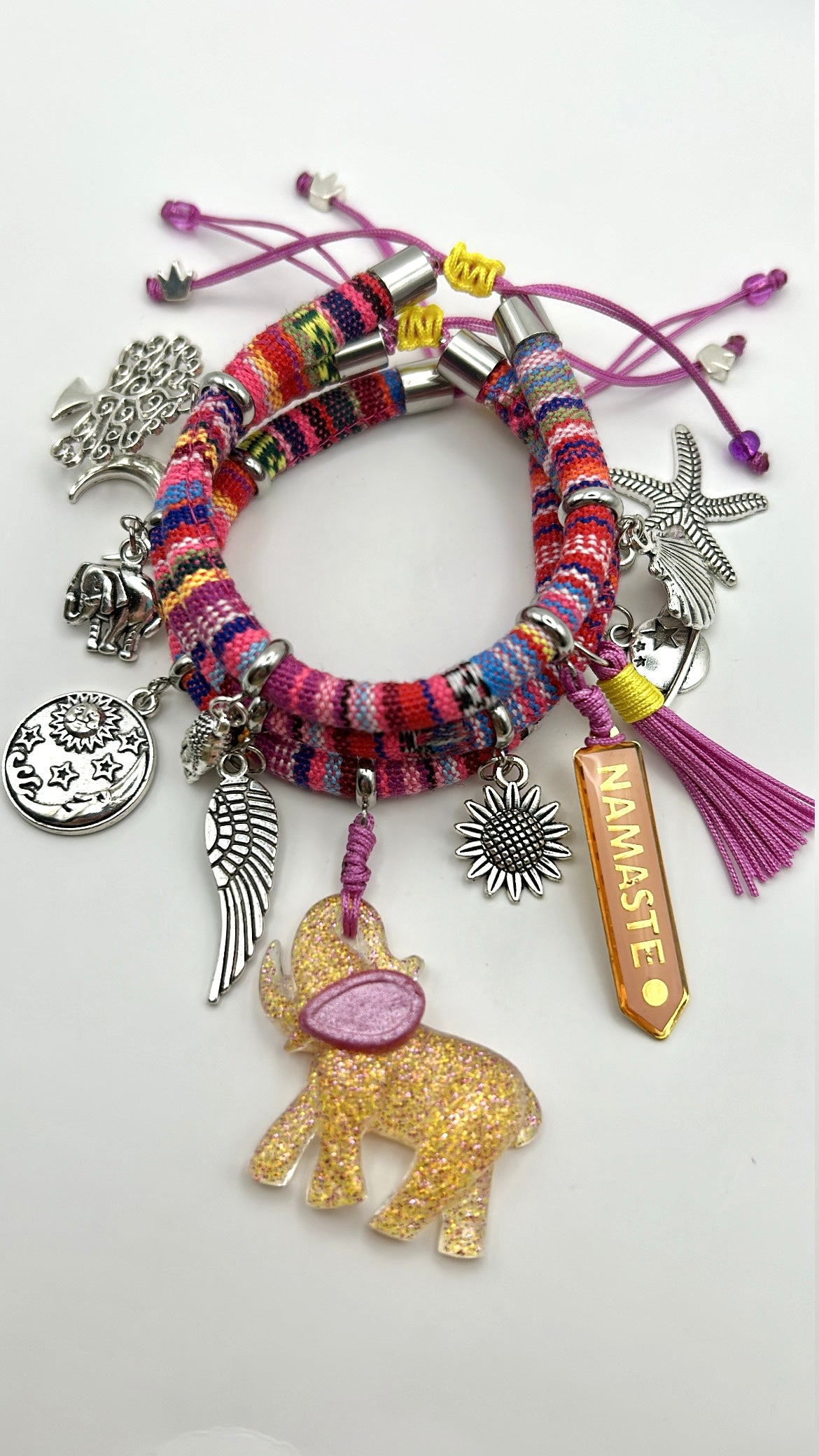 Colorful bracelet with various charms on a white background