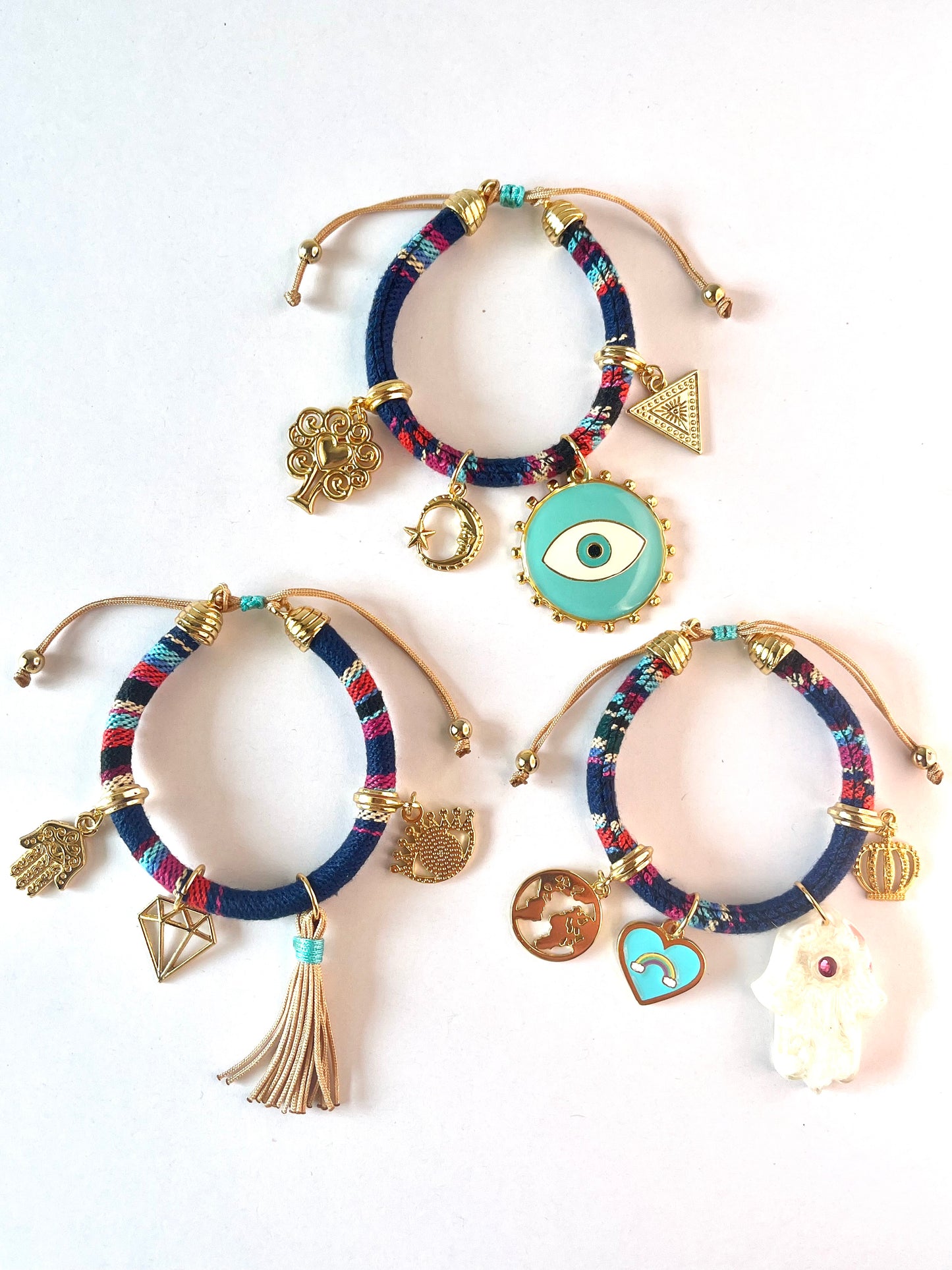 Dark blue bracelet with turquoise evil eye and white Hamsa hand close-up, showing woven cord and gold accents – IsabellaByShop