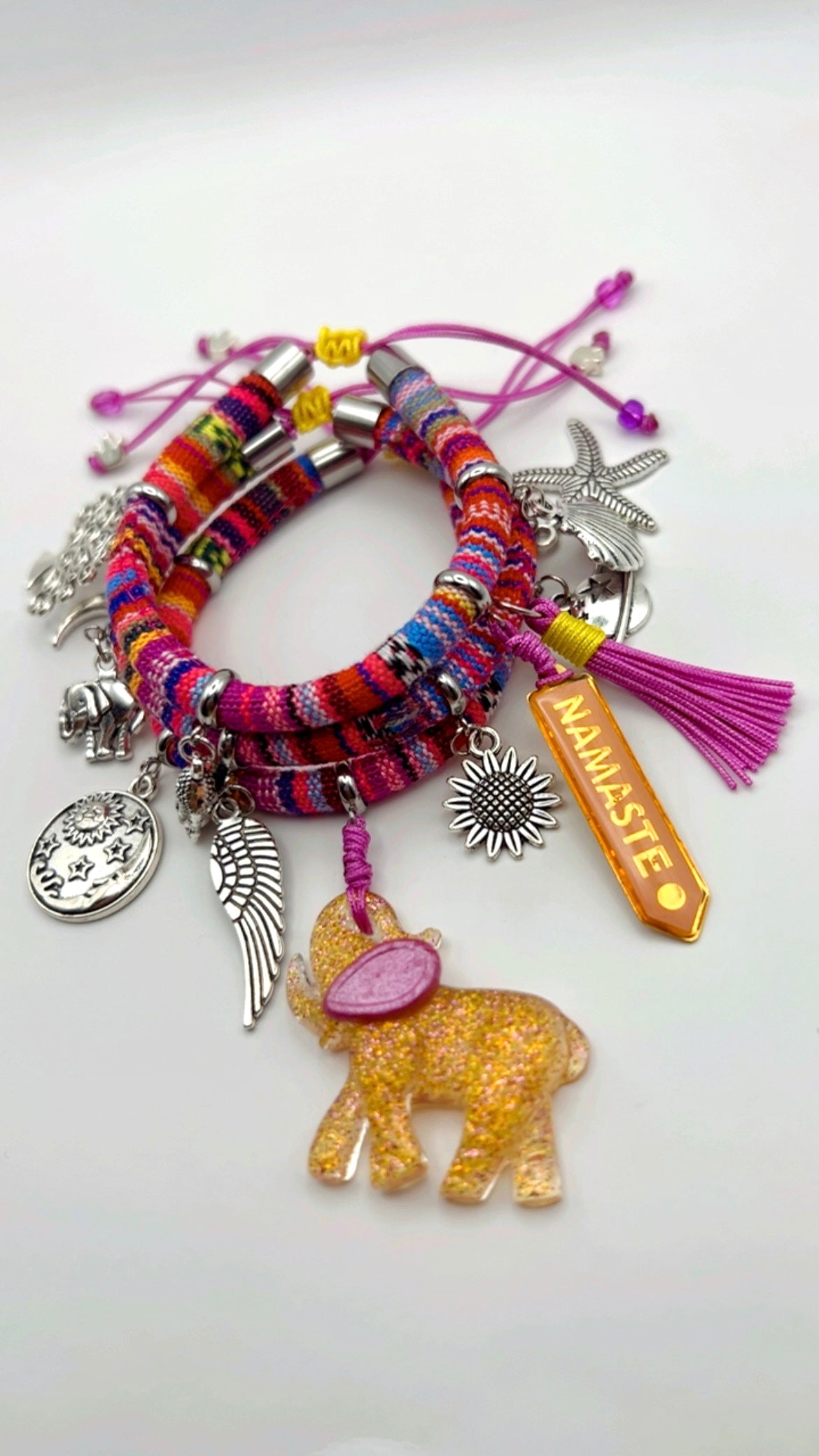 Colorful bracelet with various charms on a white background