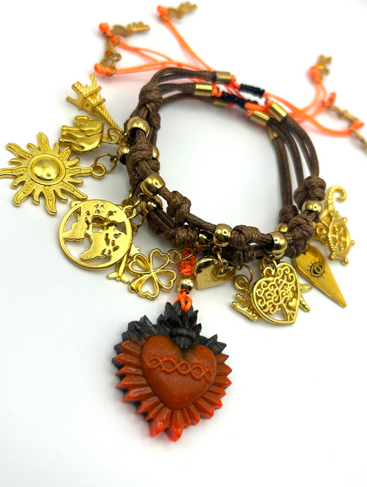 Multicolored bracelet with various charms including a heart, sun, and moon on a white background