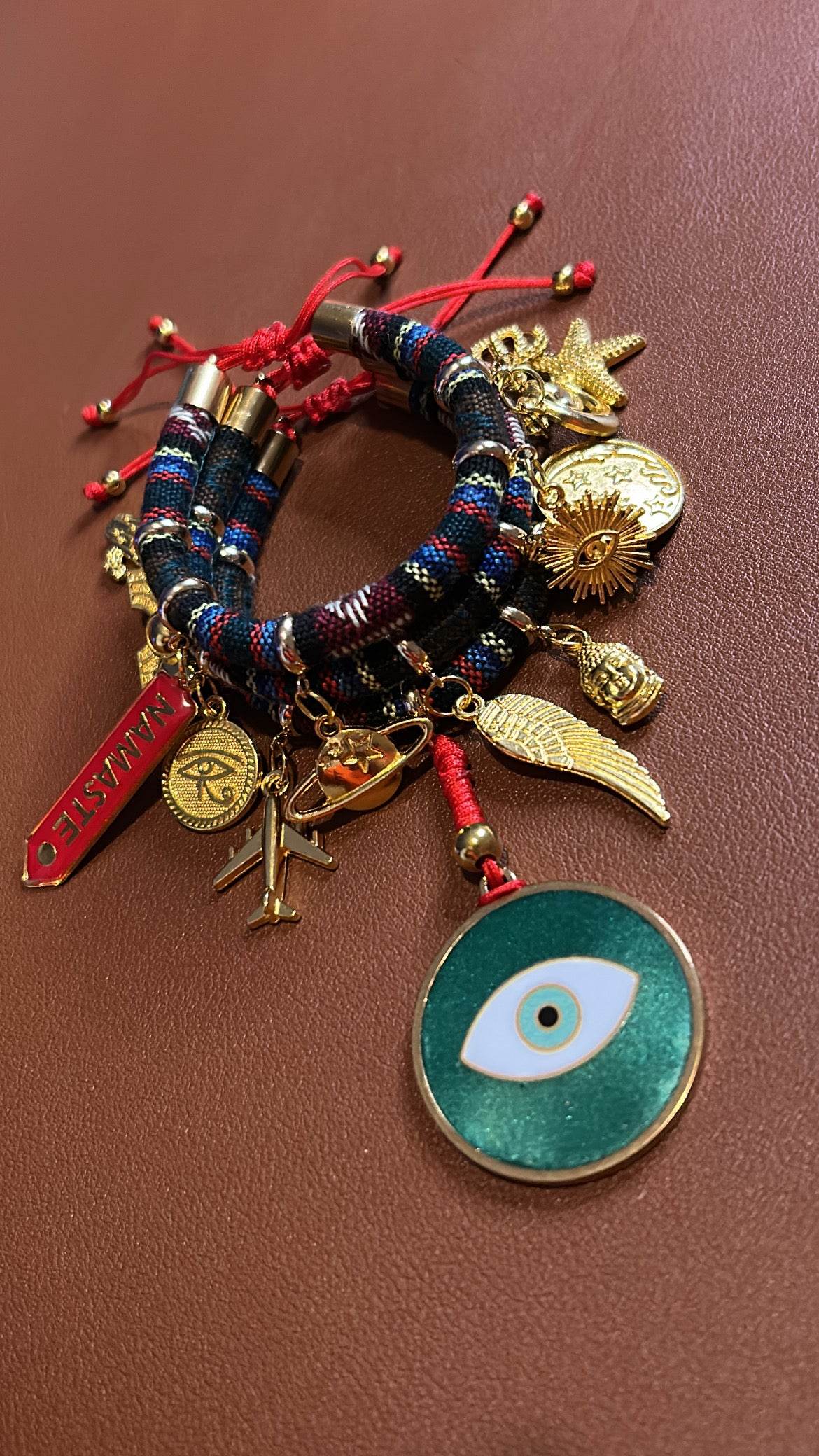 Multicolored bracelet with various charms on a brown background