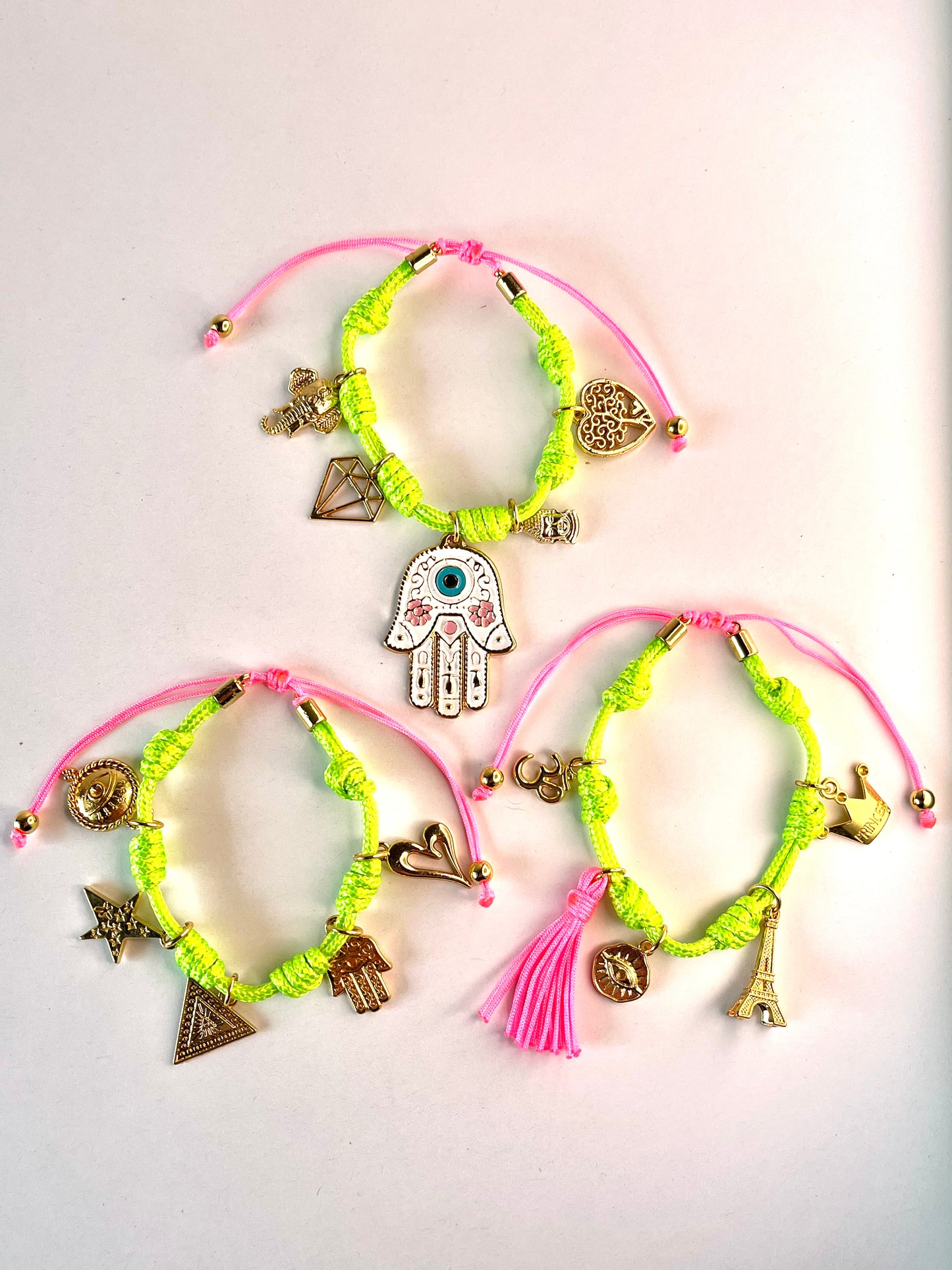 Neon Green Vibora Bracelet with White Hamsa Hand, Pink Cord and Lucky Charms.