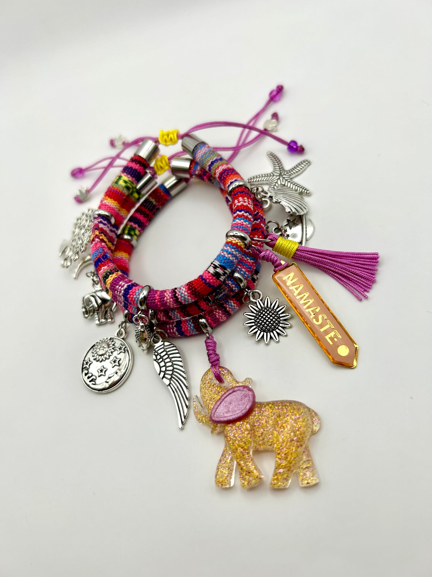 Colorful bracelet with various charms on a white background