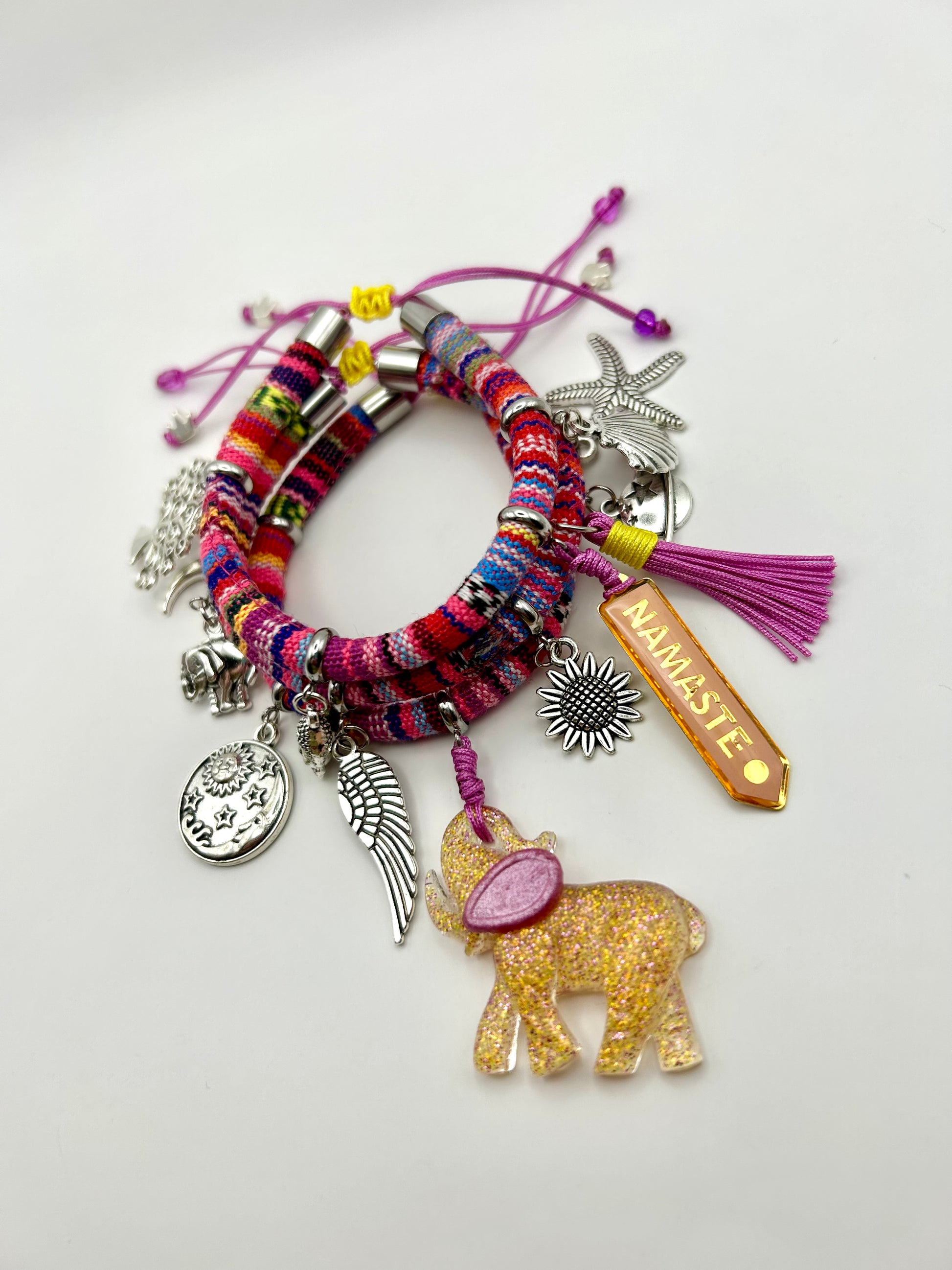 Colorful bracelet with various charms on a white background