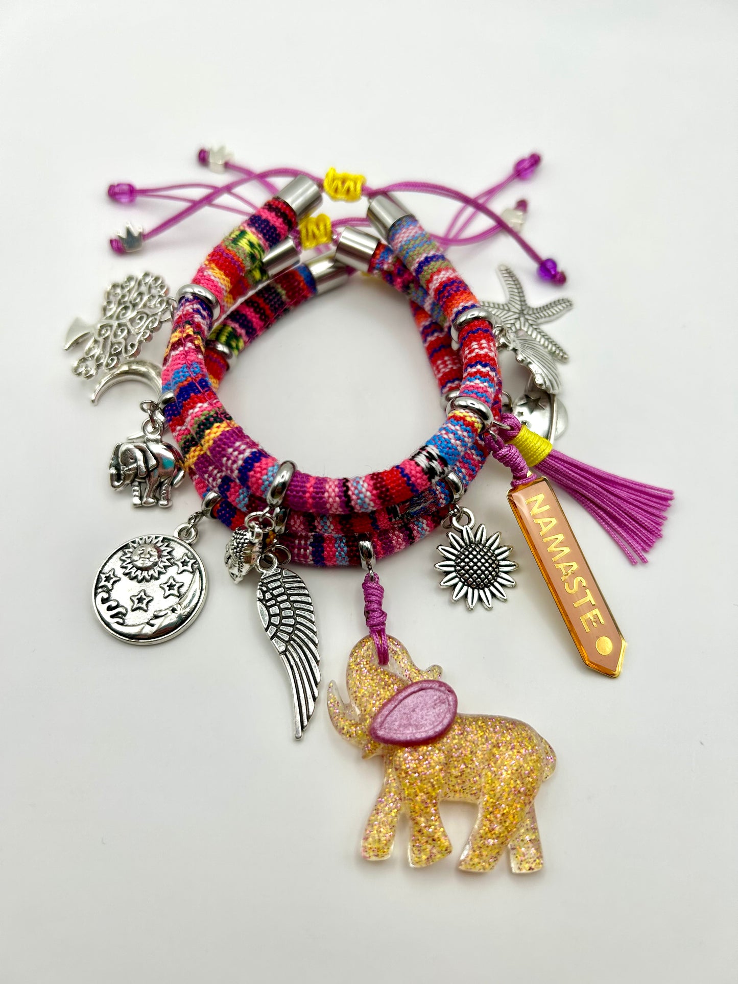 Colorful bracelet with various charms on a white background