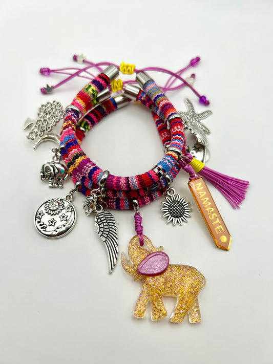Colorful bracelet with various charms on a white background